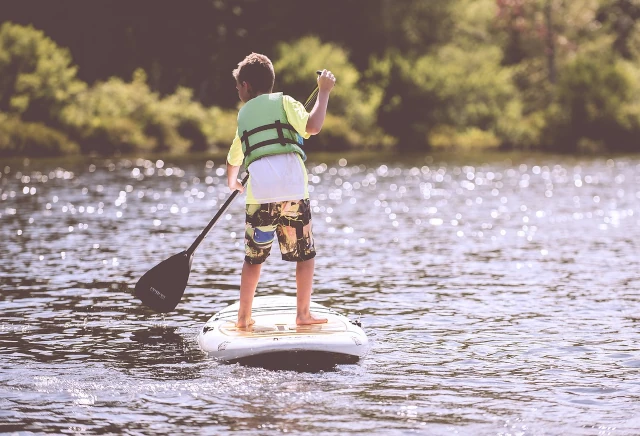Boy paddles on river Vaal River Parys